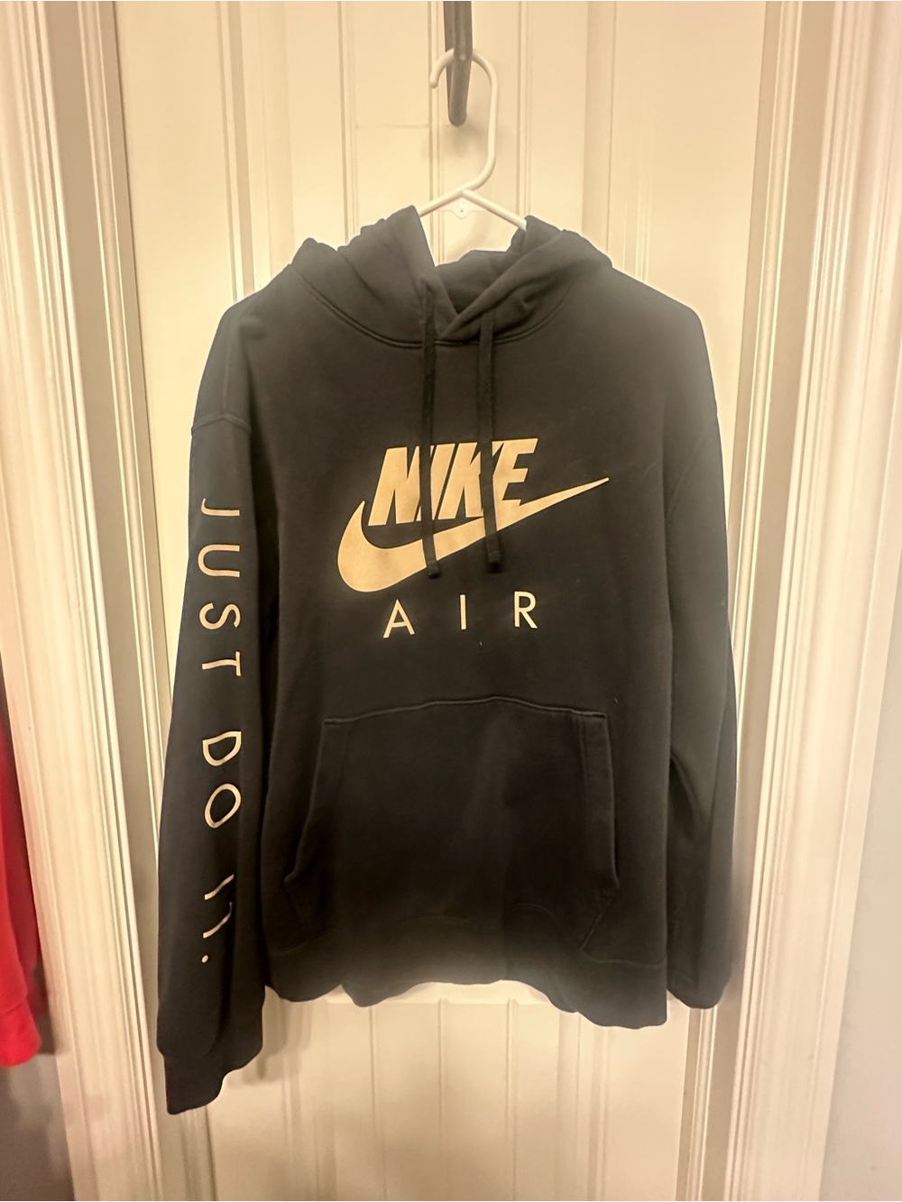 Nike Black hoodie with metallic gold writing.